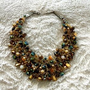 Stunning statement bib necklace. Different shades of green and golds.